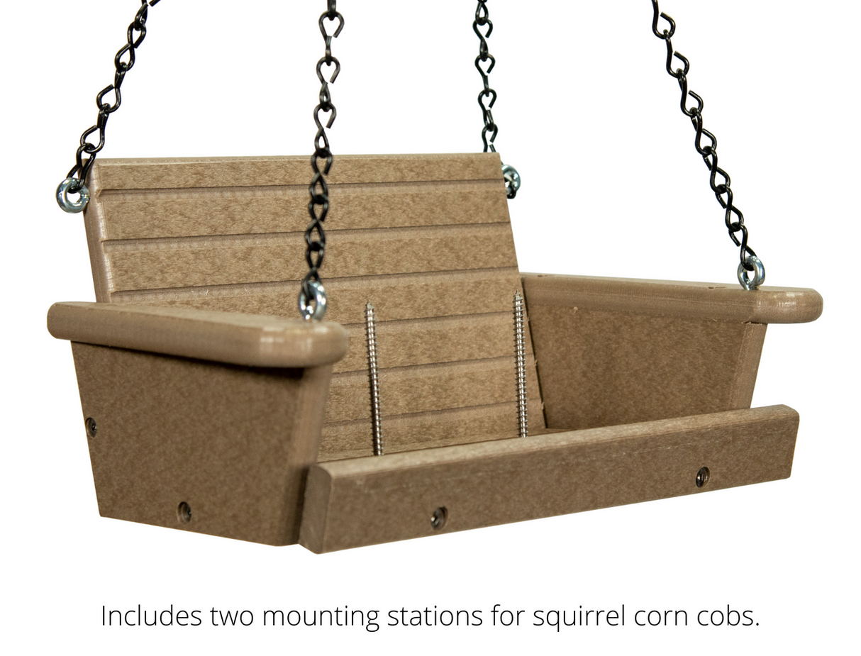 Product image of a taupe plastic squirrel feeder swing with black chains, two corn cob mounts, and visible screws