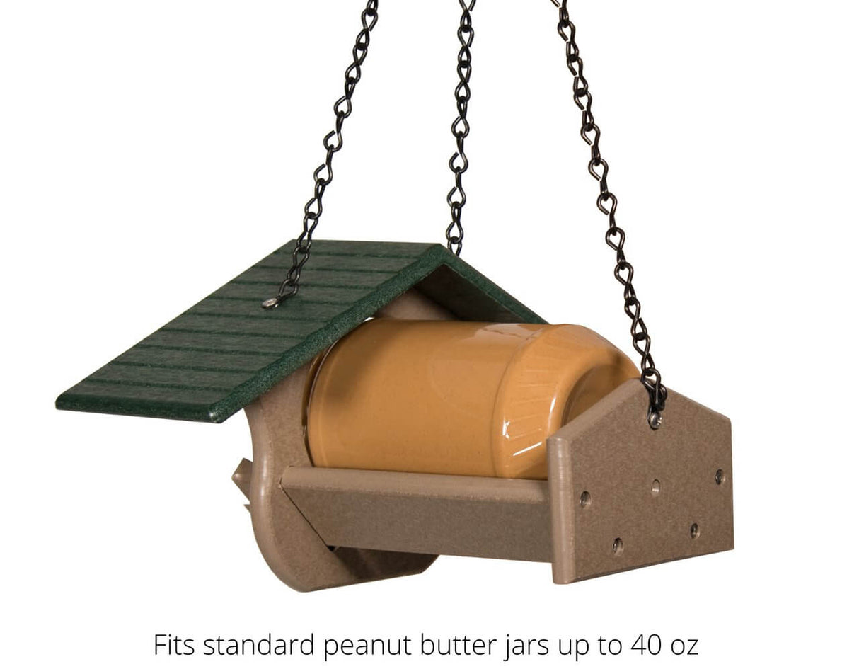 JCS Wildlife PB Pit Stop Peanut Butter Feeder hanging with a peanut butter jar, eco-friendly design for bird feeding.