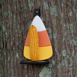 JCS Wildlife Candy Corn Squirrel Feeder holding dried corn on a tree trunk, perfect for feeding squirrels.