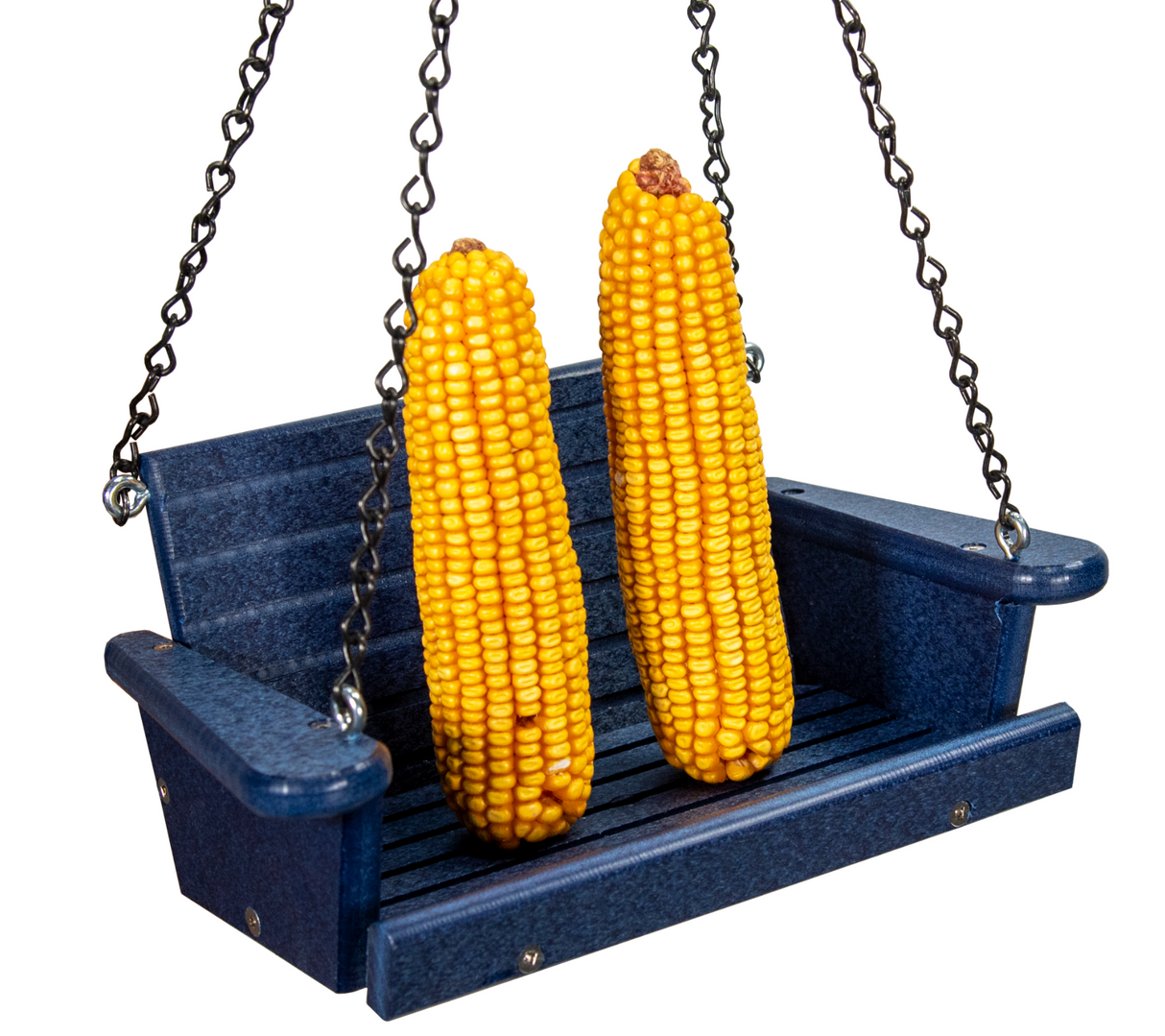Photograph two ears of bright yellow corn sitting on a miniature navy blue plastic swing hanging from black chains