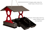 Product shot of a red and gray plastic bird feeder with a removable tray and hanging cable showing  a dark gray peaked roof and  two convenient black seed trays
