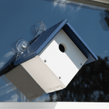 JCS Wildlife Recycled Poly Lumber Window-Mount Wren House attached to a window, ideal for attracting nesting birds.