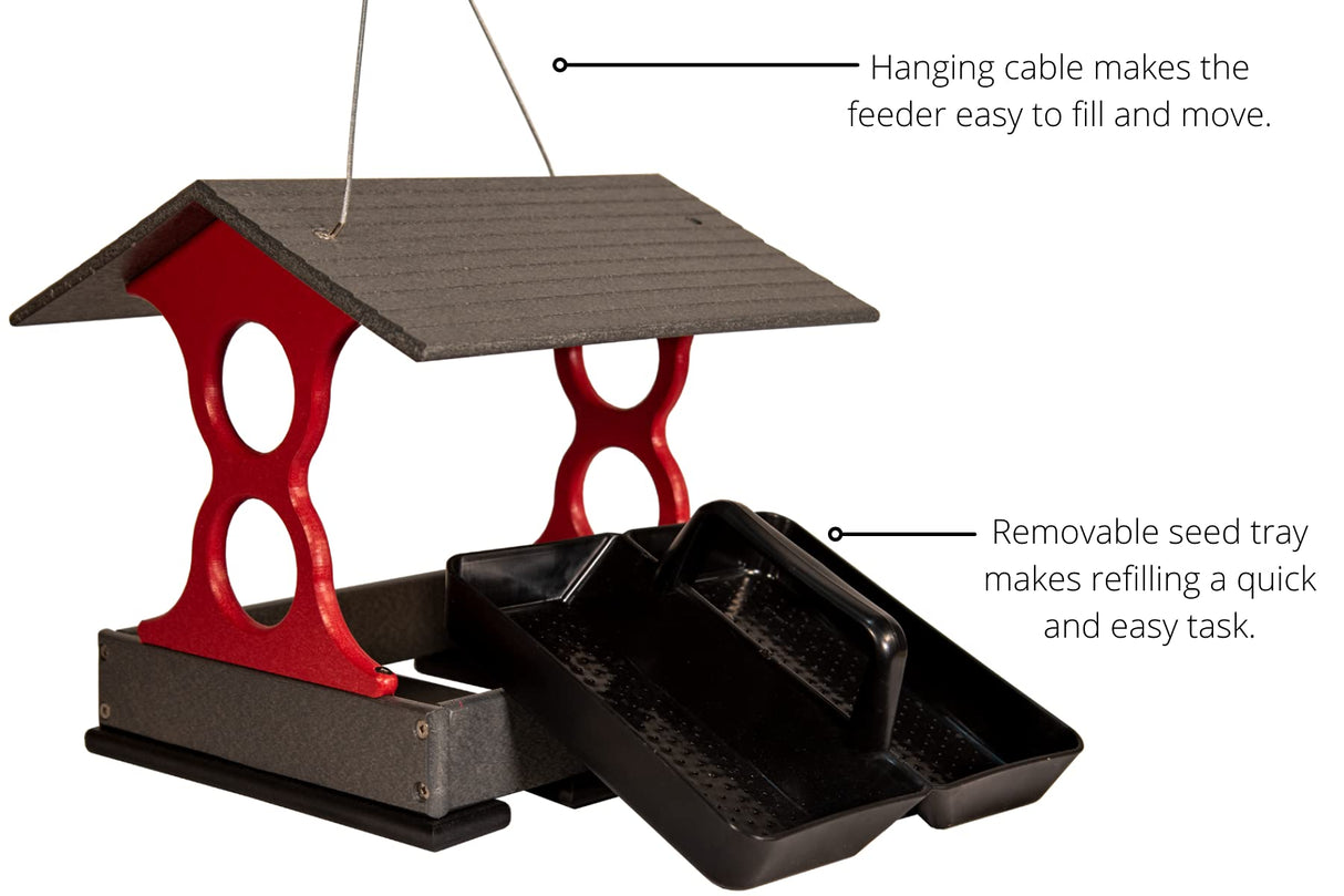 Product shot of a red and gray plastic bird feeder with removable trays and a hanging cable showing a gray peaked roof and  perforated black seed trays
