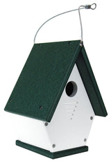 Recycled plastic birdhouse featuring a dark green roof, white body, and silver hanging wire showing ventilation slots and a circular entry hole
