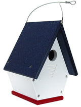 Plastic birdhouse with a navy blue roof, white walls, and red base featuring a hanging wire and ventilation slots
