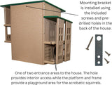 Product image showing a tan and green plastic multi-level squirrel house with two entry areas, multiple platforms, and a mounting bracket
