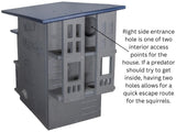 Plastic Nutty Mansion squirrel house with multiple levels, two entrances, a dark blue roof, and gray textured walls
