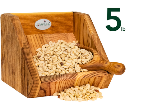 JGs Wildlife wooden feeder filled with five pounds of creamy-colored peanuts  a  wooden scoop rests inside  showing rich wood grain and a logo on the side
