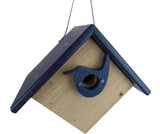 Wooden birdhouse with a dark blue roof and bird-shaped entrance hole featuring brass screws and a light wood body hanging against a white background
