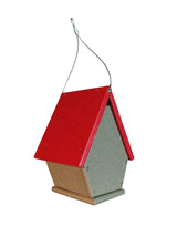 Recycled plastic birdhouse with a red roof and gray body hanging by a wire  showing visible screws and a small landing platform
