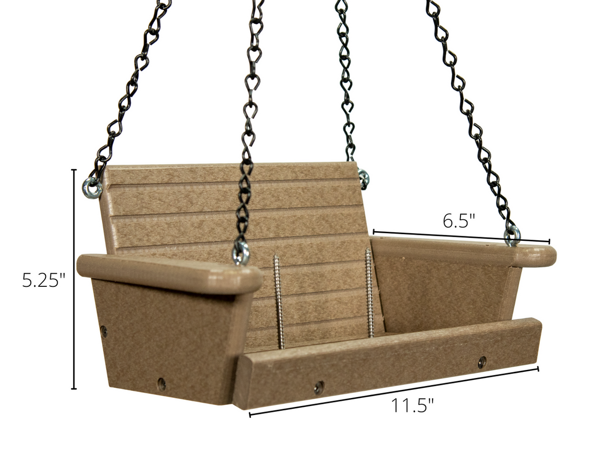 Product shot of a beige plastic bird feeder swing with black chains and silver screws showing dimensions 115 x 65 x 525 inches