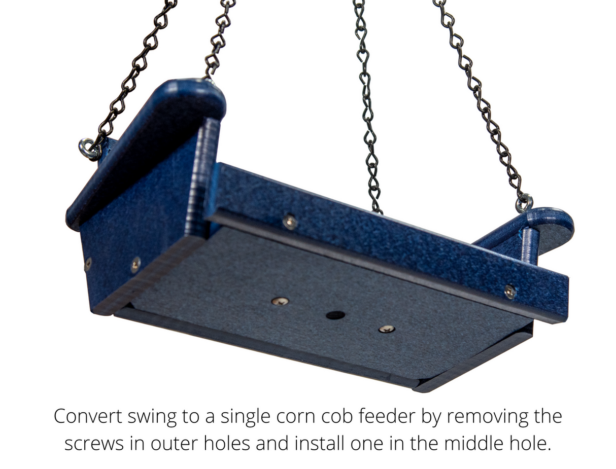 Product Photography: A dark blue plastic bird feeder swing with visible screws and chains hanging from the top against a white background
