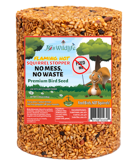 JCS Wildlife product photography shows a cylindrical package of Flaming Hot Squirrel Stopper Premium Bird Seed featuring a cartoon squirrel, sunflower seeds, peanuts, and cranberries against a green tree backdrop
