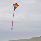 Rainbow Arch 27" diamond kite flying in the sky with long fabric tails. Perfect for novice to intermediate kite enthusiasts and family fun.