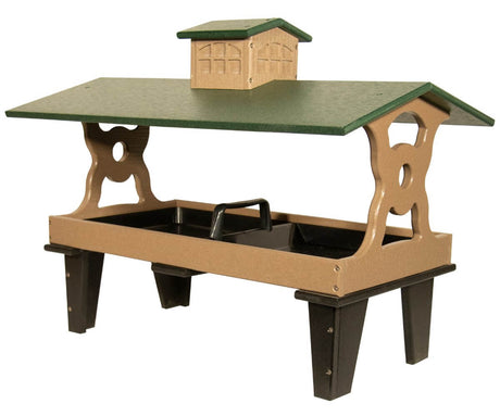 JCS Wildlife Colossal Ground Fly Thru Feeder with green roof and brown base, holds 16 cups of bird seed.