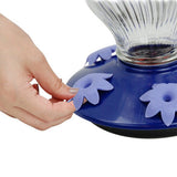 Hand assembling Perky-Pet Grand Oasis Top-Fill Glass Hummingbird Feeder with flower-shaped feeding ports