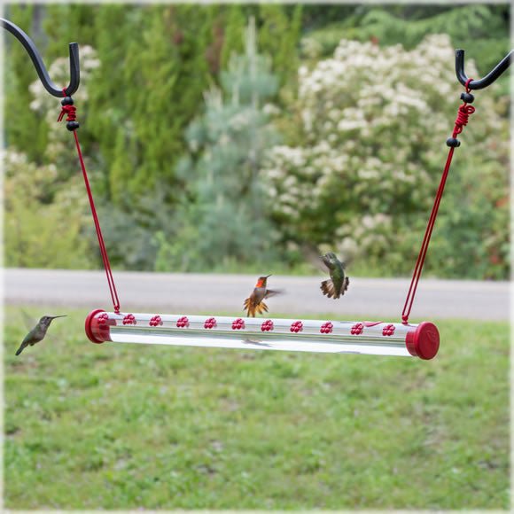 Perky-Pet Hummerbar Hummingbird Feeder with 22 feeding ports attracting hummingbirds in a garden setting